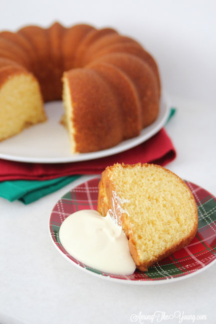 The Best Egg Nog Pound Cake featured by top Utah Foodie blog, Among the Young: image of cake with cream