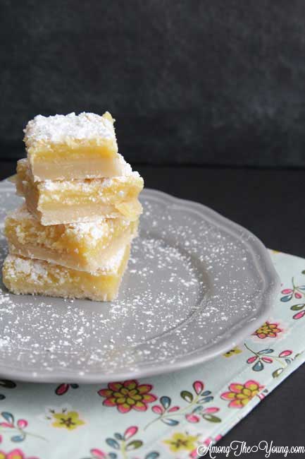 The Best Lemon Bars Recipe in the World, featured by top US food blog, Among the Young: image of powdered sugar on Lemon Bars