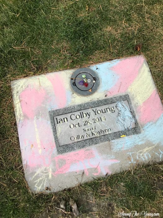 sibling loss by top Utah lifestyle blog, Among the Young: image of chalk on the grave | Sibling Loss: 7 Essential Tips to Help your Child Grieve by popular Utah lifestyle blog, Among the Young: image of a headstone. 