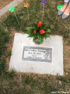 How to help a child grieve featured by top Utah lifestyle blog, Among the Young: image of pinwheels at the grave"