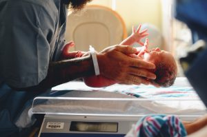 10 things to do in the hospital after baby featured by top Utah Lifestyle blog, Among the Young: image of baby on scale