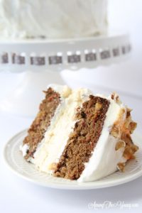 Carrot cake cheesecake cake featured by top Utah Foodie blog, Among the Young: image of sliced cake