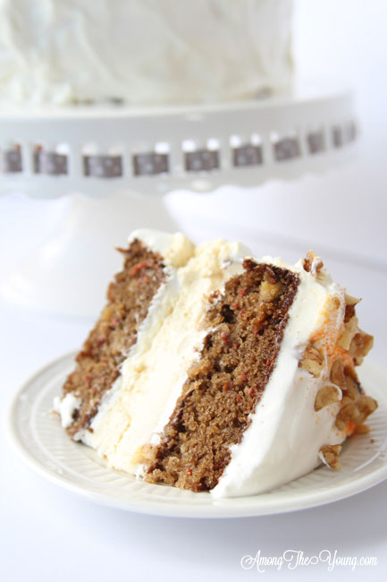 Carrot cake cheesecake cake featured by top Utah Foodie blog, Among the Young: image of sliced cake | The Ultimate Carrot Cake Cheesecake Cake Recipe by popular US food blog, Among the Youngs: image of carrot cake cheesecake. 