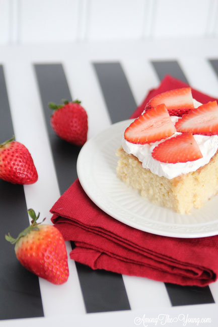 The most delicious tres leches cake featured by top Utah Foodie blog, Among the Young: image of tres leches cake and strawberries | Easy Tres Leches Recipe by popular Utah lifestyle blog, Among the Young: Pinterest image of Tres Leches cake. 