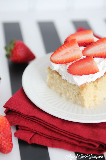 The most delicious tres leches cake featured by top Utah Foodie blog, Among the Young: image of cake and berries | Easy Tres Leches Recipe by popular Utah lifestyle blog, Among the Young: Pinterest image of Tres Leches cake. 