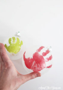 The cutest DIY handprint ornament featured by top Utah craft blog, Among the Young: image of young and old handprint