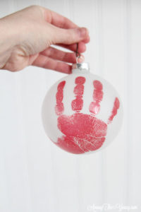 The cutest DIY handprint ornament featured by top Utah craft blog, Among the Young: image of big red hand ornament