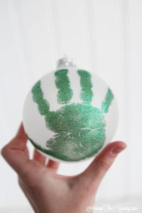 The cutest DIY handprint ornament featured by top Utah craft blog, Among the Young: image of dark green ornament