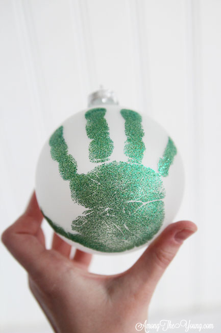 The cutest DIY handprint ornament featured by top Utah craft blog, Among the Young: image of dark green ornament | How to make the cutest DIY handprint ornament by popular Utah life and style blog, Among the Young: image of a DIY handprint ornament.