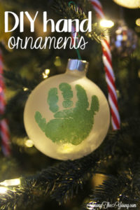 The cutest DIY handprint ornament featured by top Utah craft blog, Among the Young: image of green handprint ornament in tree PIN