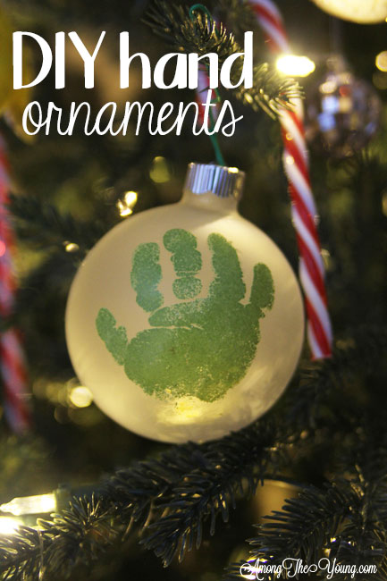 The cutest DIY handprint ornament featured by top Utah craft blog, Among the Young: image of green handprint ornament in tree PIN | How to make the cutest DIY handprint ornament by popular Utah life and style blog, Among the Young: image of a DIY handprint ornament.