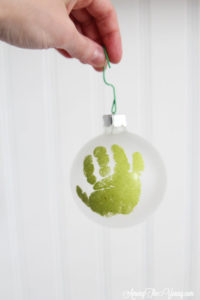 The cutest DIY handprint ornament featured by top Utah craft blog, Among the Young: image of green handprint ornament