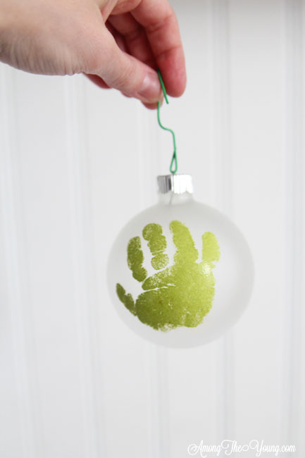 The cutest DIY handprint ornament featured by top Utah craft blog, Among the Young: image of green handprint ornament | How to make the cutest DIY handprint ornament by popular Utah life and style blog, Among the Young: image of a DIY handprint ornament.