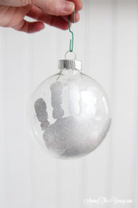 The cutest DIY handprint ornament featured by top Utah craft blog, Among the Young: image of silver hand