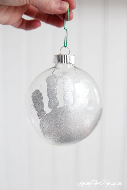 The cutest DIY handprint ornament featured by top Utah craft blog, Among the Young: image of silver hand | How to make the cutest DIY handprint ornament by popular Utah life and style blog, Among the Young: image of a DIY handprint ornament.