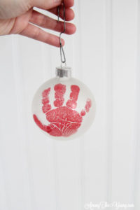 The cutest DIY handprint ornament featured by top Utah craft blog, Among the Young: image of red handprint
