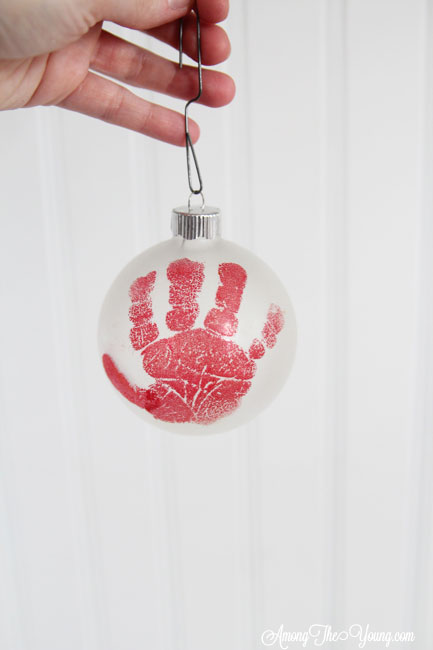 The cutest DIY handprint ornament featured by top Utah craft blog, Among the Young: image of red handprint | How to make the cutest DIY handprint ornament by popular Utah life and style blog, Among the Young: image of a DIY handprint ornament.