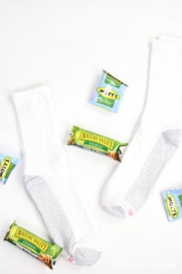 How to give back to the community this Christmas season featured by top Utah lifestyle blog, Among the Young: image of socks and granola bars