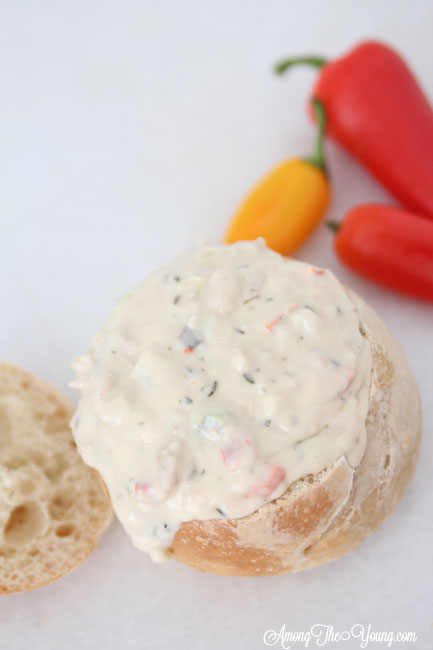 The best Disneyland Clam chowder featured by top Utah Foodie blog, Among the Young: image of clam chowder dripping out of bread bowl | Copycat Recipes: Disneyland Clam Chowder Recipe by popular Utah food blog, Among the Young: image of copycat Disneyland clam chowder in a bread bowl. 