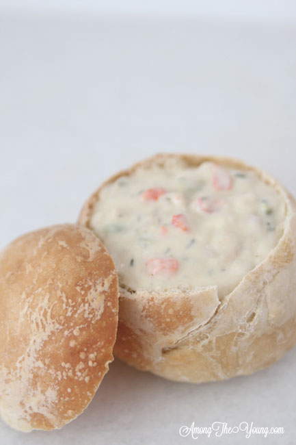 The best Disneyland Clam chowder recipe featured by top Utah Foodie blog, Among the Young: image of clam chowder in bread bowl | Copycat Recipes: Disneyland Clam Chowder Recipe by popular Utah food blog, Among the Young: image of copycat Disneyland clam chowder in a bread bowl. 