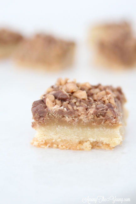 The Best Almond Roca Cookie bars featured by top Utah Foodie blog, Among the Young: image of Almond Roca Cookie bar in focus | Almond Roca by popular Utah lifestyle blog, Among the Young: image of Almond Roca cookie bars. 