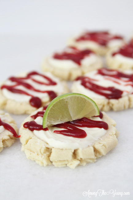 The most amazing raspberry lime sugar cookies featured by top Utah Foodie blog Among the Young: image of cookies in a diagonal line | Key Lime Raspberry Sugar Cookies by popular Utah food blog, Among the Young: image of key lime raspberry sugar cookies.