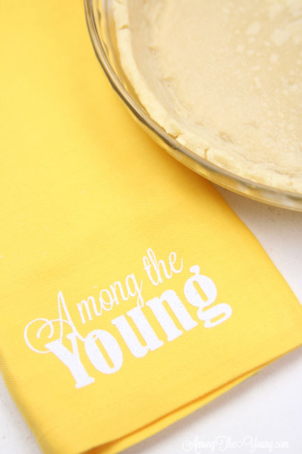 vodka pie crust recipe by top Utah Foodie Among the Young: image of yellow napkin |Vodka Pie Crust Recipe by popular Utah lifestyle blog, Among the Young: image of a vodka pie crust next to a yellow Among the young tea towel. 