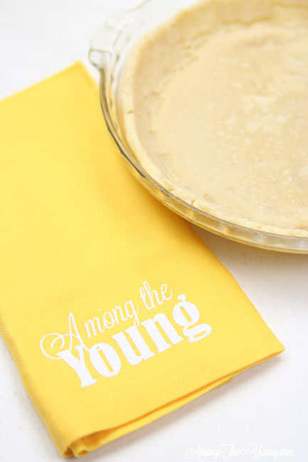 vodka pie crust recipe by top Utah Foodie Among the Young: image of yellow napkin and pie |Vodka Pie Crust Recipe by popular Utah lifestyle blog, Among the Young: image of a vodka pie crust next to a yellow Among the young tea towel. 