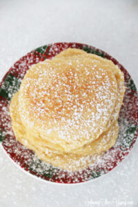 The best ricotta pancakes recipe featured by top Utah Foodie Among the Young: image of ricotta pancakes with powdered sugar