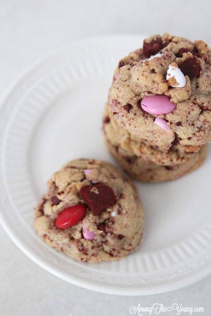 The Best Valentines Cookie featured by top Utah Foodie blog Among the Young: image of one red velvet oreo cookie on a plate |Browned Butter Cookies by popular Utah food blog, Among the Young: image of browned butter red velvet Oreo M&M cookies. 