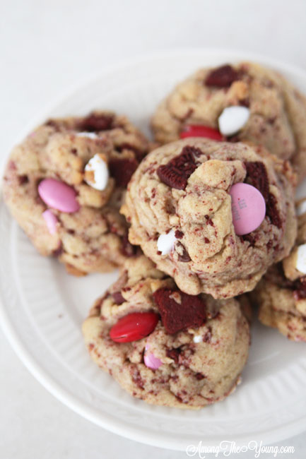 The Best Valentines Cookie featured by top Utah Foodie blog Among the Young: image of lots of red velvet oreo cookies on a plate |Browned Butter Cookies by popular Utah food blog, Among the Young: image of browned butter red velvet Oreo M&M cookies. 