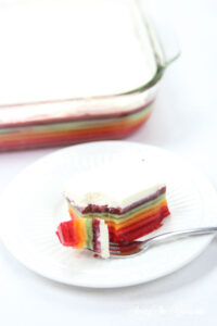 The best rainbow Jello featured by top Utah Foodie blog Among the Young: image of bite of Jello