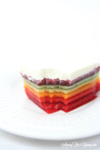 The best rainbow Jello featured by top Utah Foodie blog Among the Young: image of Jello with a bite taken out of it