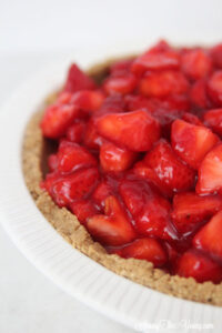 The best strawberry cream pie featured by top Utah Lifestyle blog Among the Young: image of strawberry cream pie close up