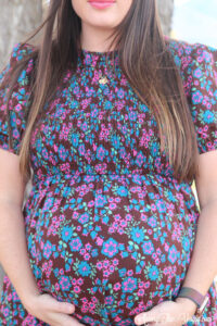 The best Non-Maternity dresses featured by top Utah fashion blog Among the Young: image of super close up bump